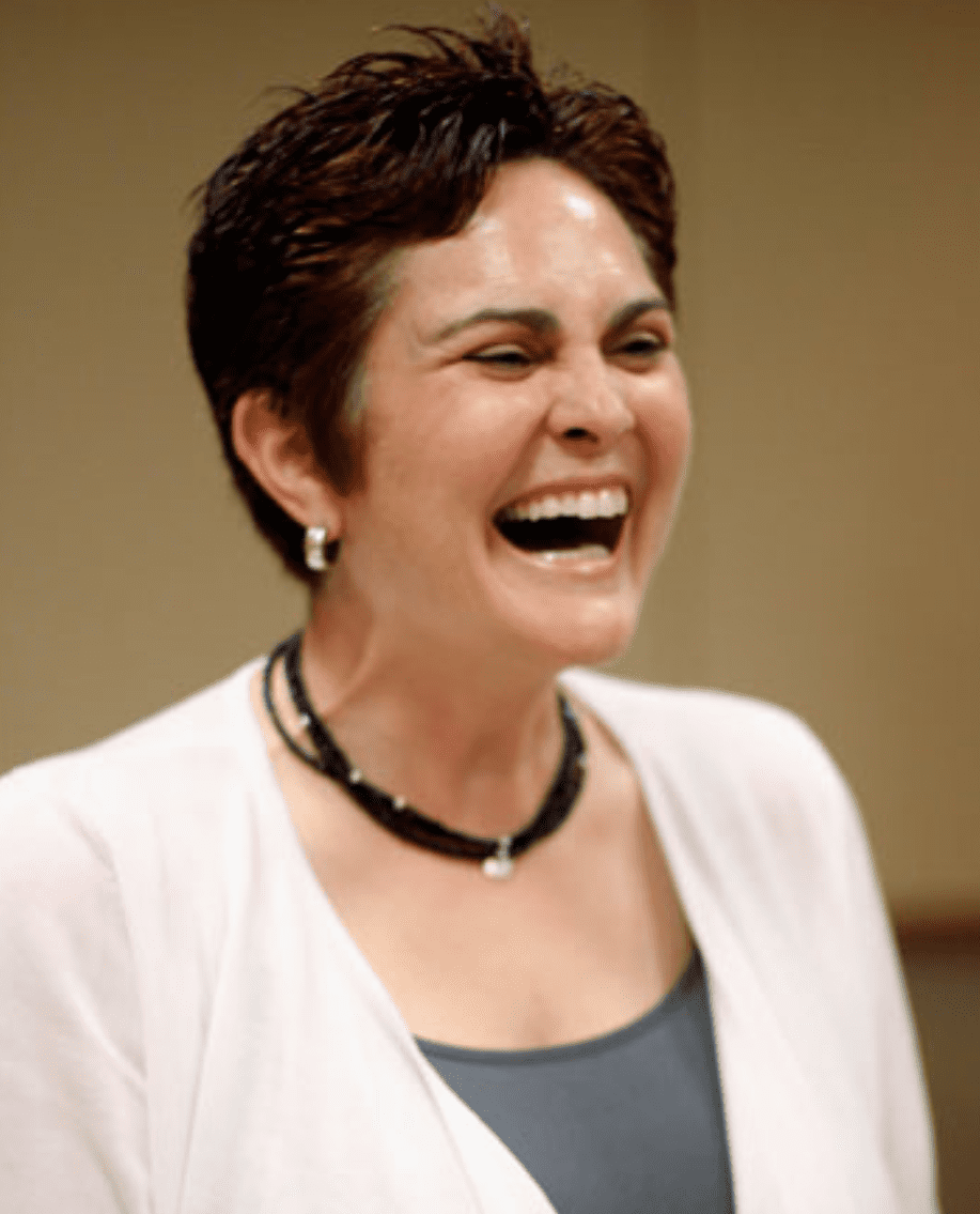 a person laughing with short hair